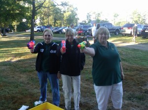 Pam, Ruth & Linda using paint guns to paint a picture.